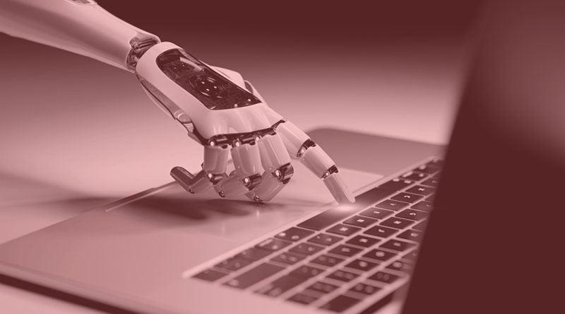 AI in payment processing depicted by robot hand pressing on laptop keyboard