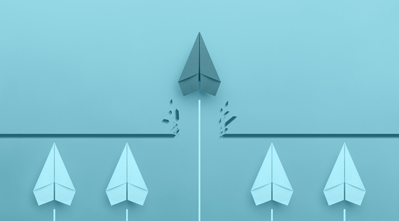 Line of paper airplanes with one breaking through a line to the other side